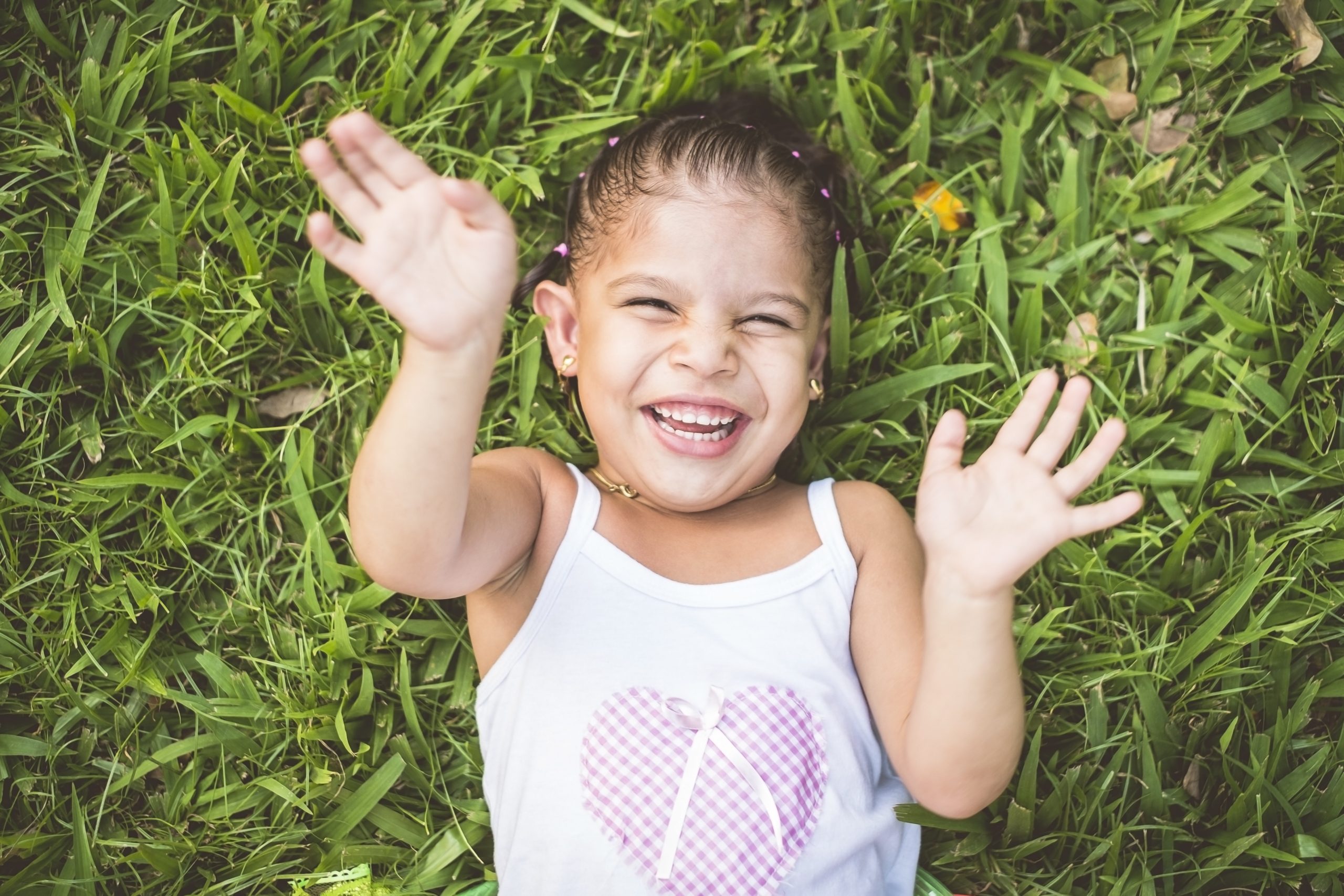 happy girl playing on grass