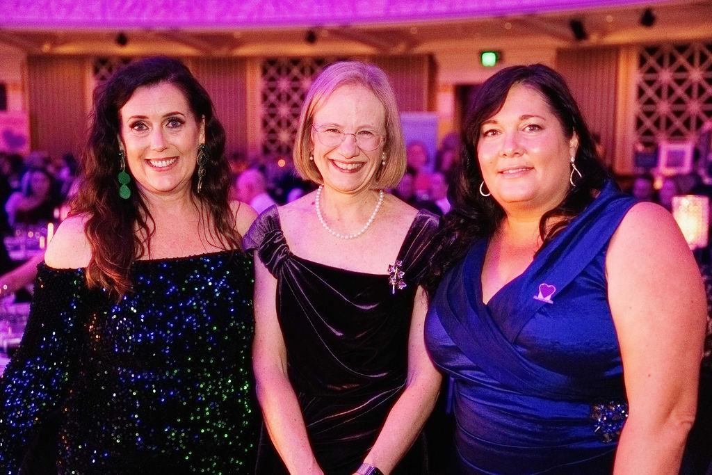 Bravehearts Ball Alison Geale Bravehearts CEO, Qld Governor Her Excellency the Honourable Dr Jeannette Young AC PSM, Vanessa Garrard, Bravehearts Chair smiling to camera and dressed in ball gowns