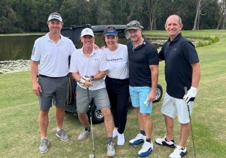 4 male golfers with Bravehearts CEO in front of golf buggy and lake