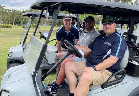 3 golfers on golf buggy