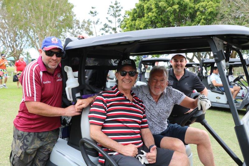 4 male golfers on buggy