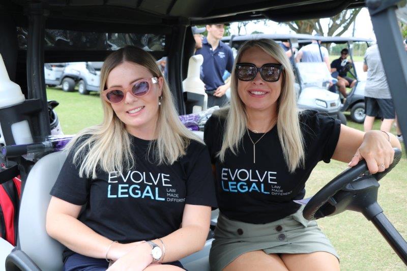 2 female Evolve Golf golfers sitting on buggy