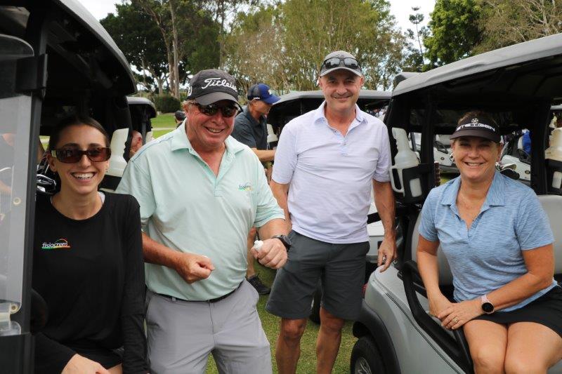 2 male and 2 female golfers on golf buggies