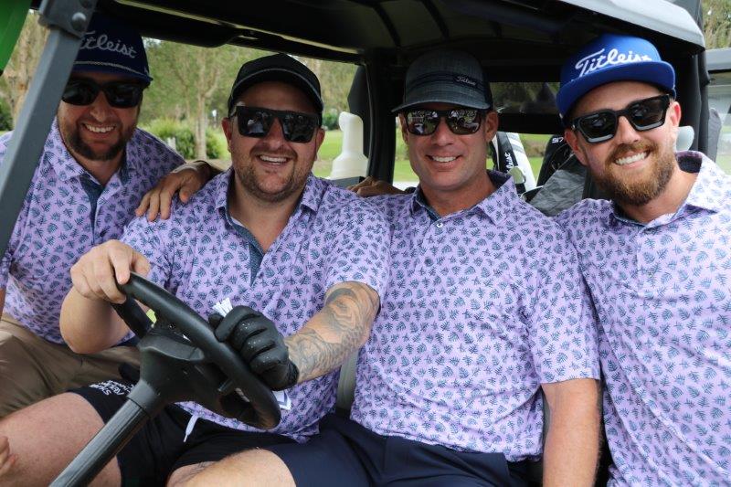 4 male golfers on buggy