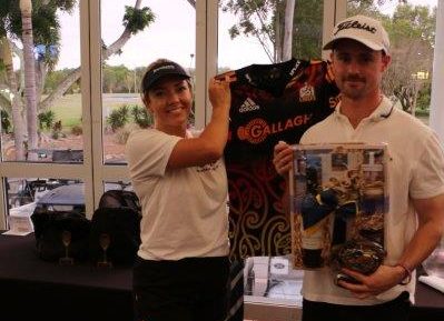 Photo of golf winner with Bravehearts Employee holding up Gallagher tshirt