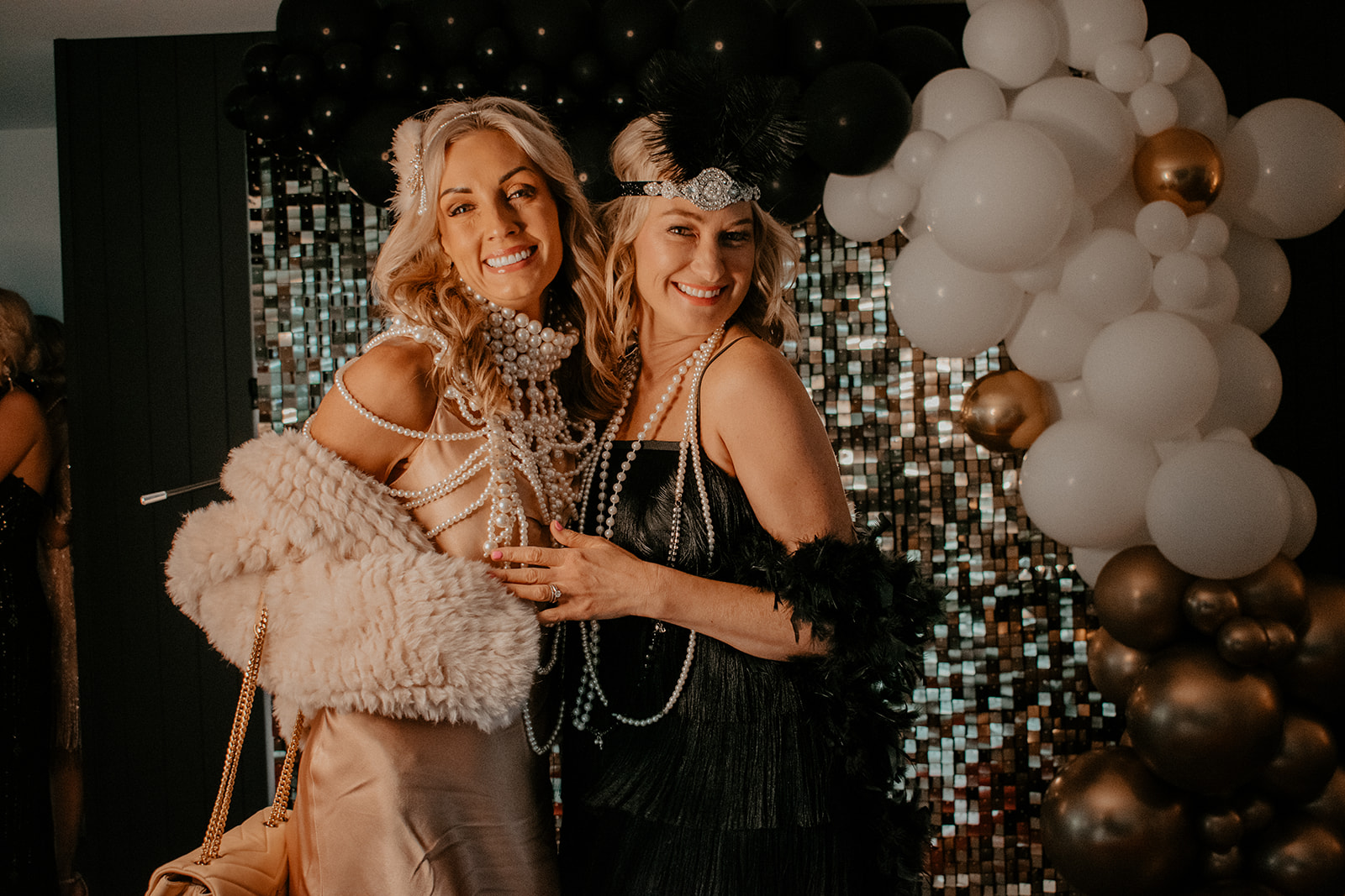 2 women in Gatsby attire smiling at camera