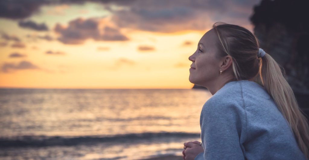 Pensive Lonely Smiling Woman Looking With Hope Into Horizon During Sunset At Beach